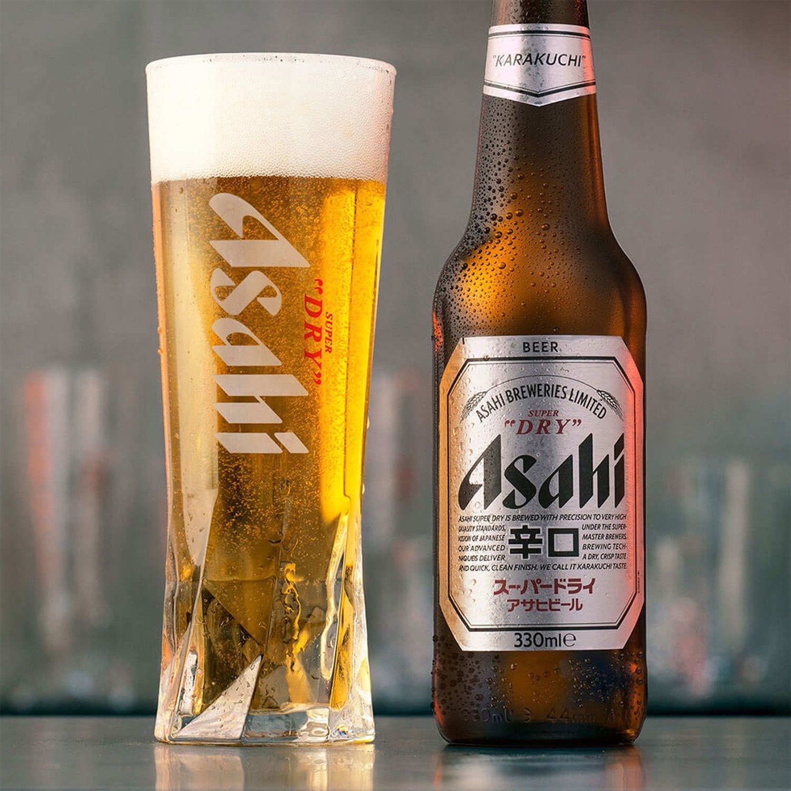 A frothy glass of Asahi Super Dry beer beside a bottle
